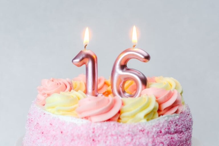 Elegant Sweet 16 cake with colorful decorations and personalized topper