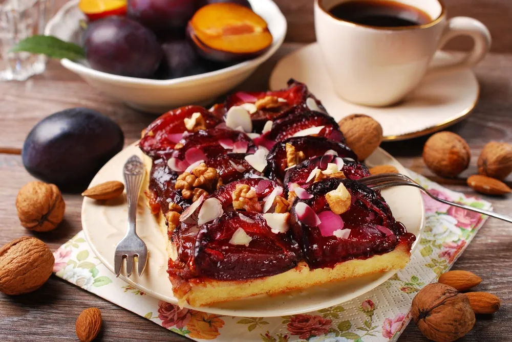 Modern multi-tier cake decorated in gradient colors with abstract textures and metallic accents